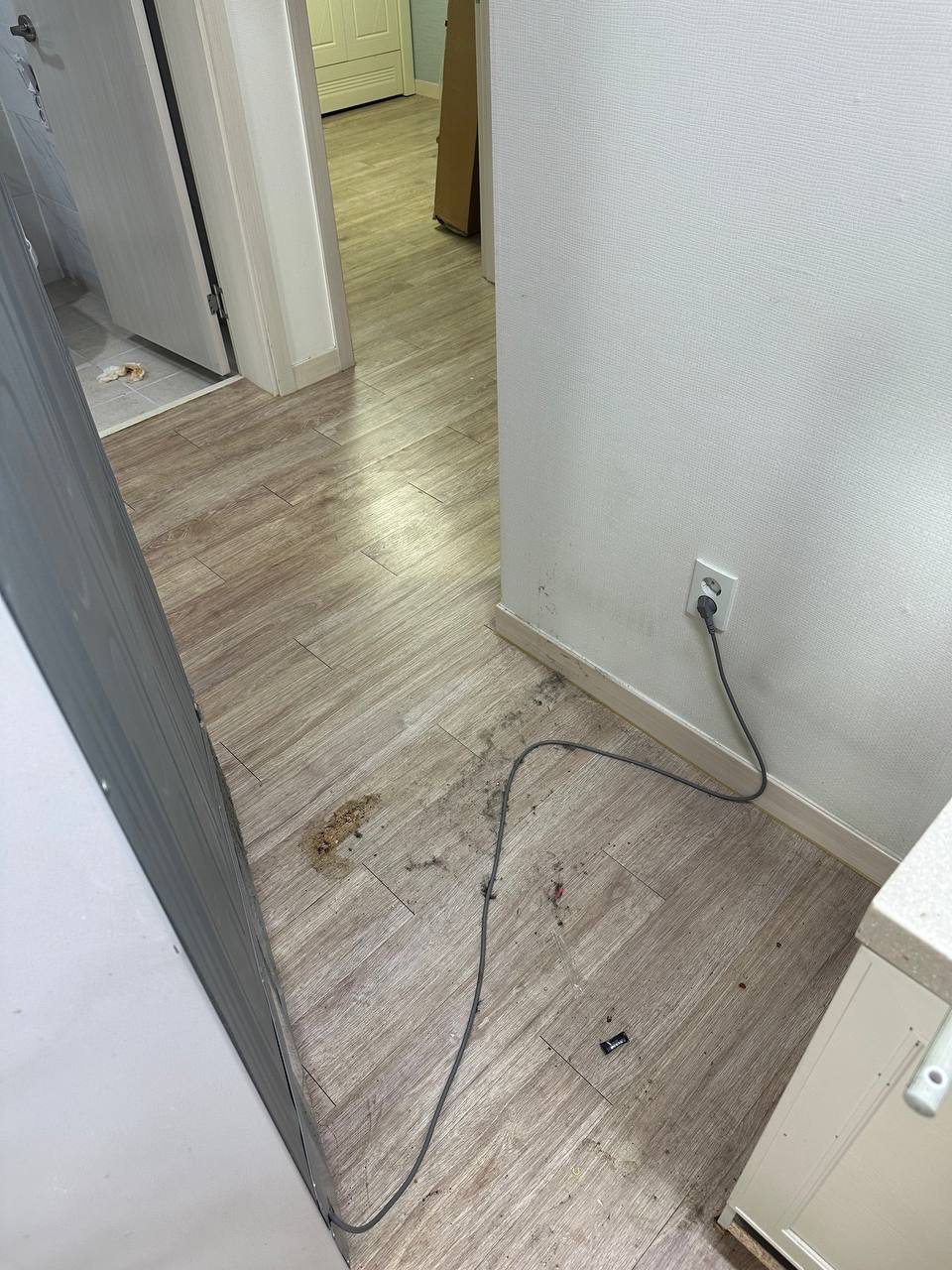 Floor behind an appliance before CLEANX cleaning