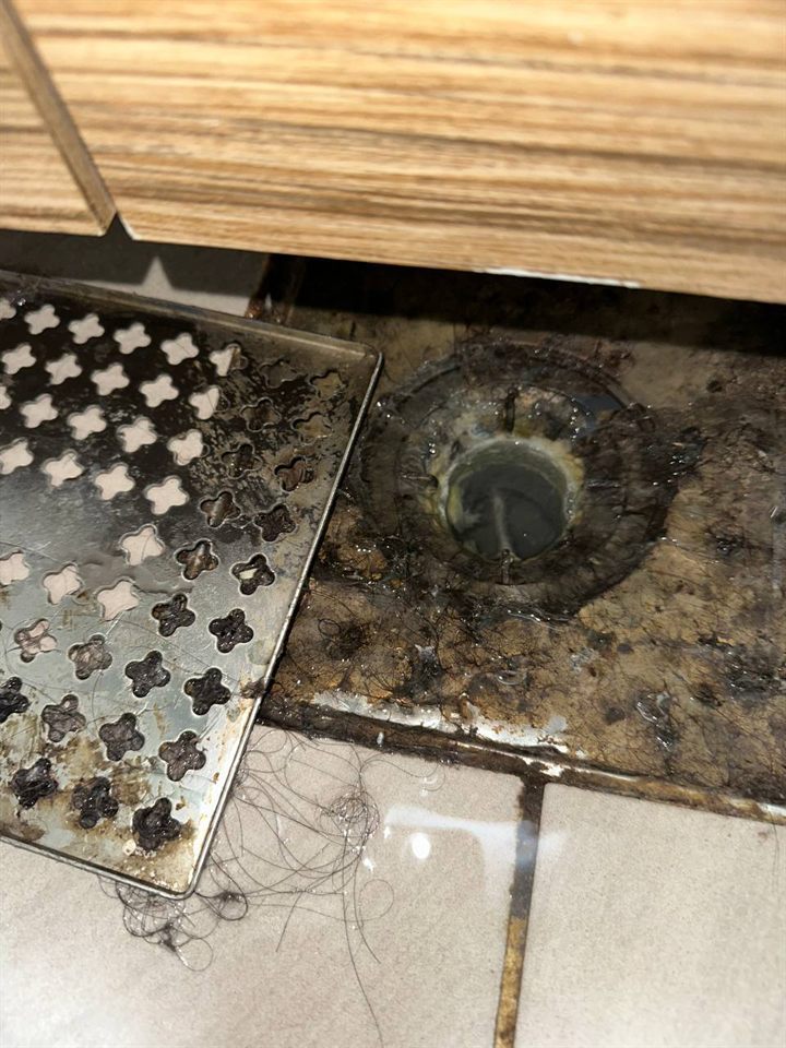 Bathroom floor drain before CLEANX cleaning