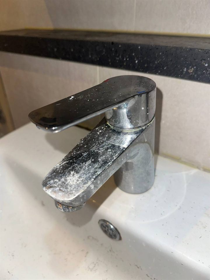 Bathroom sink faucet before CLEANX cleaning