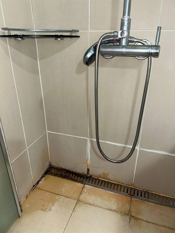 Shower floor before CLEANX cleaning